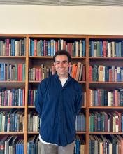 Aidan Ruppert in front of bookcase