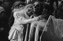 Veiled woman hugging death