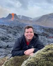 Timothy Bourns posing in front of a volcano