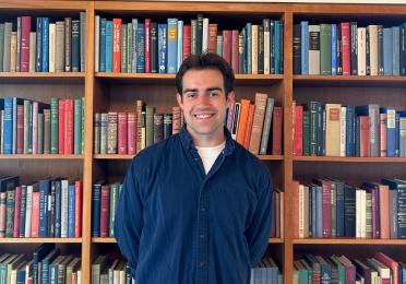 Aidan Ruppert in front of bookcase