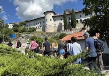 students walking through the medieval hill town of Štanjel, Slovenia