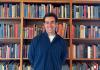 Aidan Ruppert in front of bookcase