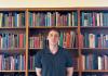 Anthony Veneziani standing in front of bookcase